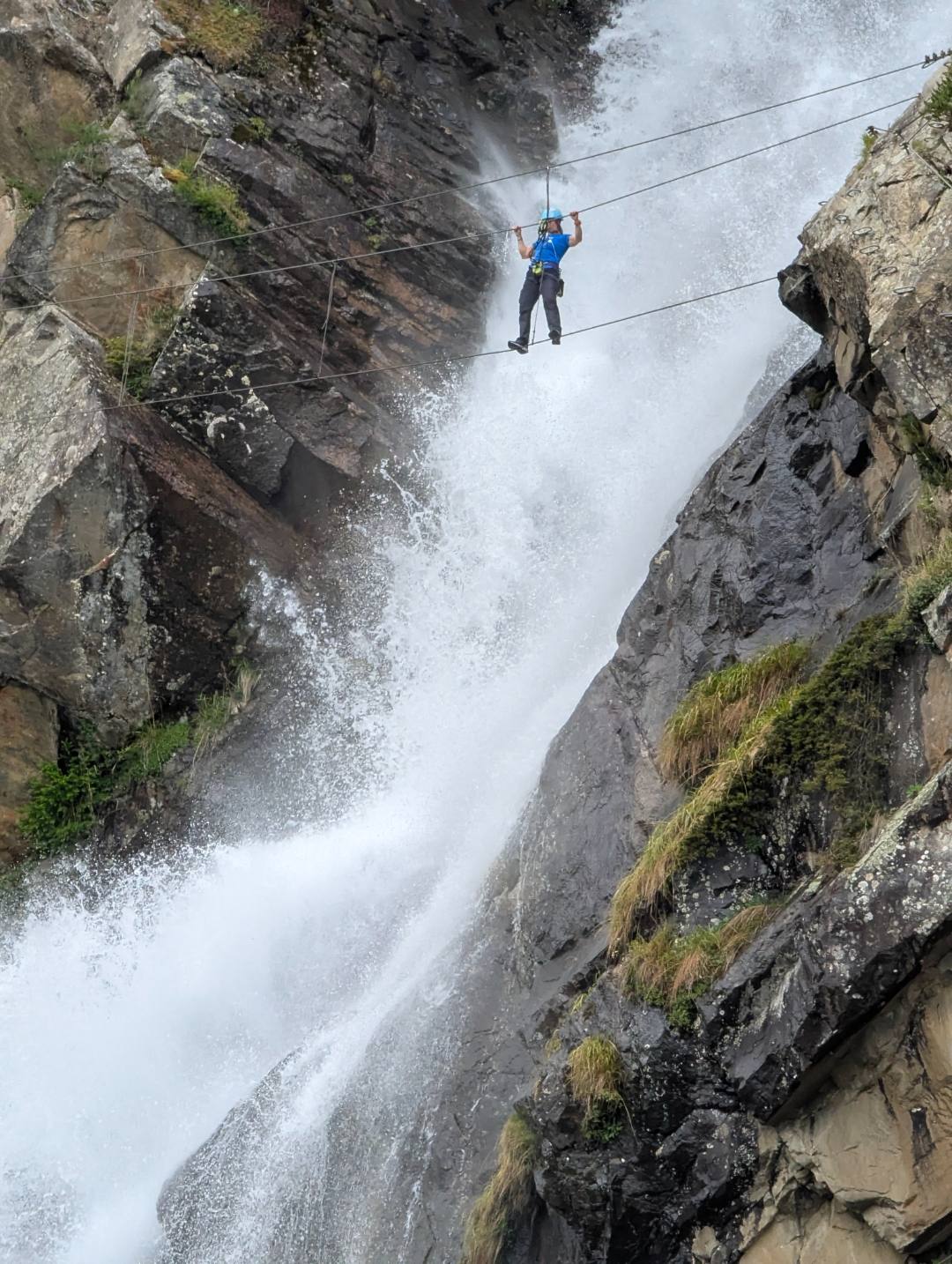 Tourists enjoying a via ferrata mountain adventure